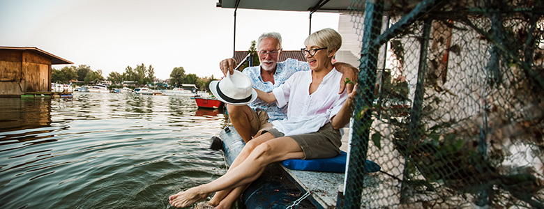 An older couple enjoys sitting by the water An older couple enjoys sitting by the water
